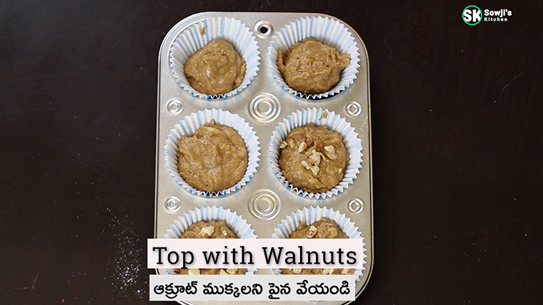 Top banana muffins mixture with walnut pieces