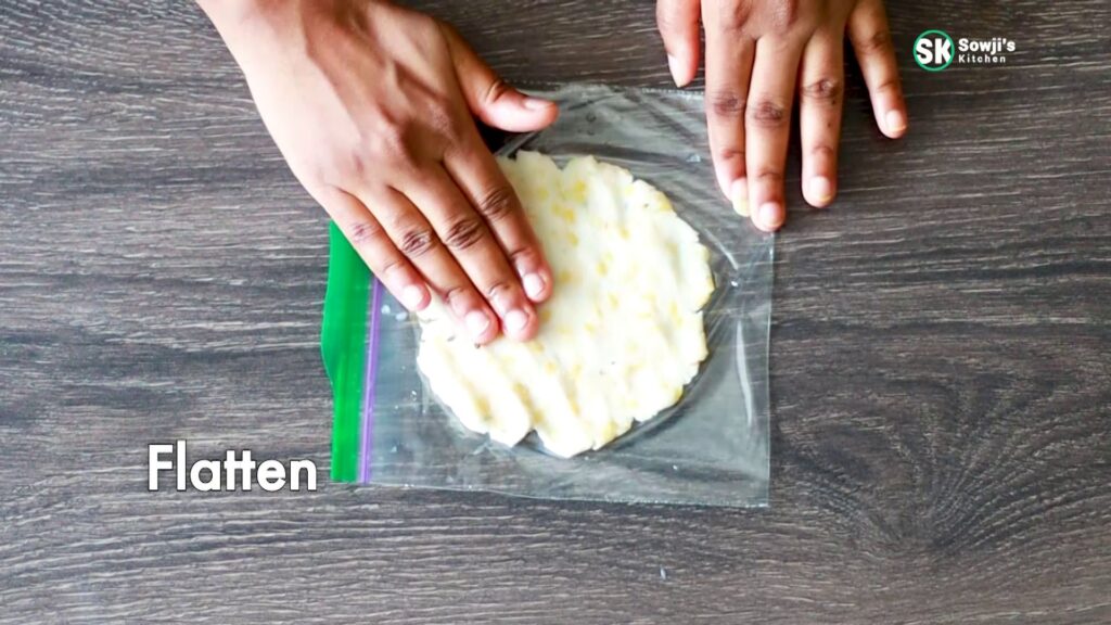 Flatten Akki roti ball by patting gently to form the rice flour moong dal roti